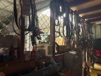 Contents to wall in cage including pulley belts, s